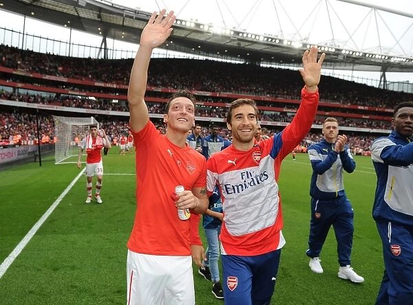 Arsenal Players Mesut Ozil and Mathieu Flamini Waving to Fans after Arsenal vs. West Bromwich Albion Match (2014 / 15)
