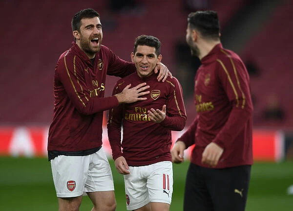 Arsenal Players Sokratis and Torreira Warm Up Ahead of Arsenal v BATE Borisov UEFA Europa League Clash