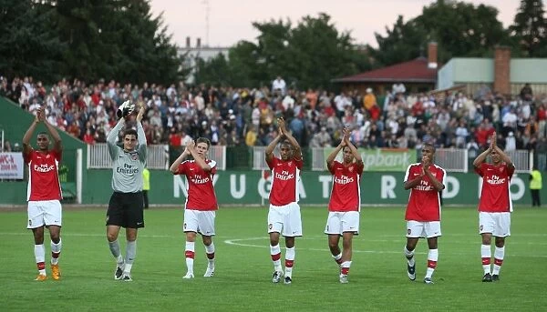 The Arsenal players wave to the fans after the match