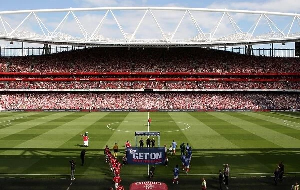 Arsenal and Portsmouth team walk out before the match