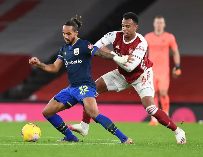Framed Print : Arsenal Rivals Clash: Gabriel vs Walcott in Empty Emirates Stadium