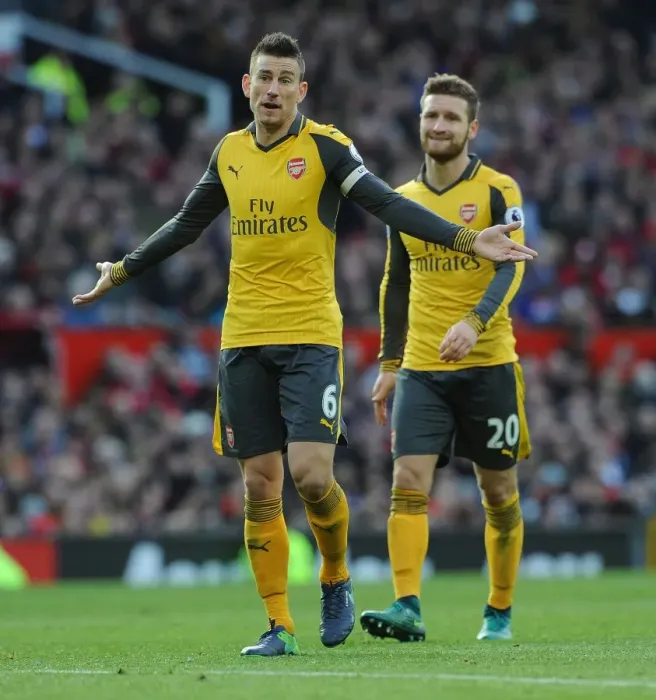Framed Print : Arsenal Rivals Koscielny and Mustafi Clash in Intense Manchester United Showdown Framed Print : Arsenal Rivals Koscielny and Mustafi Clash in Intense Manchester United Showdown