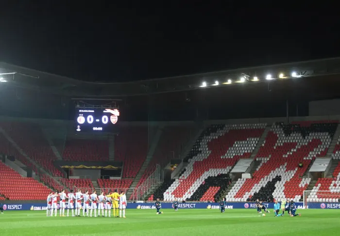 Framed Print : Arsenal and Slavia Prague Players Unite in Silence: Taking a Knee before Empty Stands in UEFA Europa League Quarterfinal, Prague, 2021