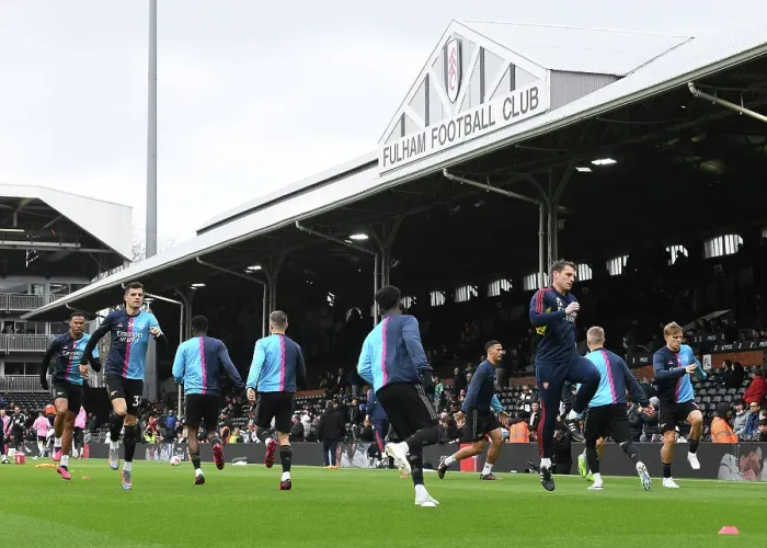 Framed Print : Arsenal Sports Scientist Tom Allen Leads Pre-Match Warm-Up at Fulham vs Arsenal (Fulham v Arsenal 2022-23)