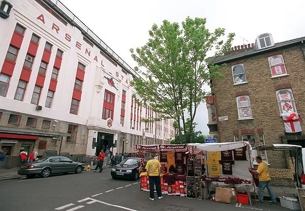 Arsenal Stadium with a house on Conewood Street with Arsenal posters in the windows