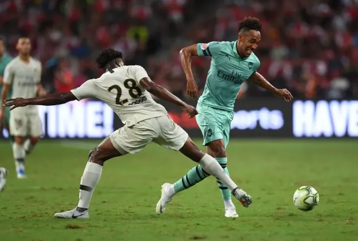 Framed Print : Arsenal Stars Clash: Aubameyang vs. Mbe Soh in Arsenal vs. PSG Showdown