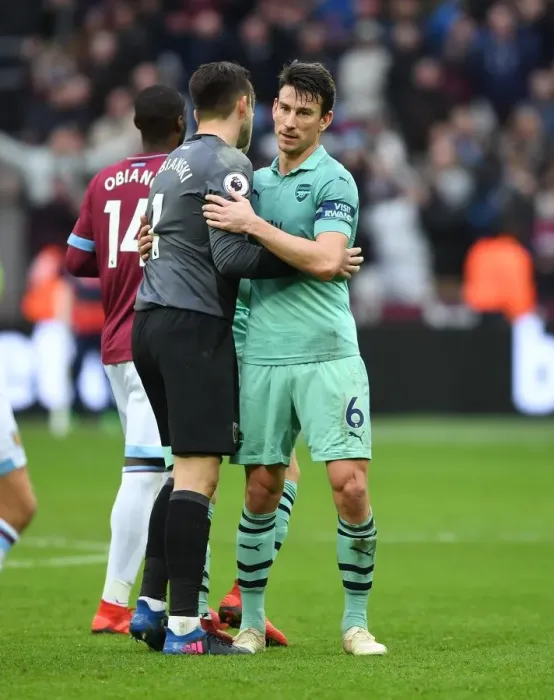 Framed Print : Former Arsenal Stars Koscielny and Fabianski Reunite: A Heartwarming Embrace on the Field Framed Print : Former Arsenal Stars Koscielny and Fabianski Reunite: A Heartwarming Embrace on the Field