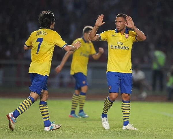 Arsenal Stars: Lukas Podolski and Tomas Rosicky Celebrate Goal Against Indonesia All-Stars
