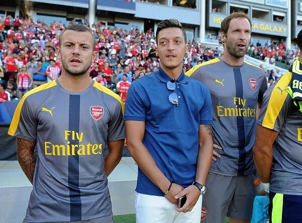 Arsenal Stars Mesut Ozil and Jack Wilshere Sharing a Moment Before the 2016-17 Match vs Chivas