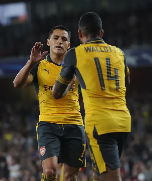 Framed Print : Arsenal Stars: Sanchez and Walcott's Unforgettable Moment of Celebration during Arsenal vs. FC Basel UEFA Champions League Match