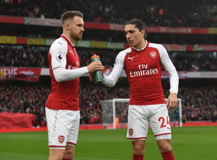 Framed Print : Arsenal Team Camaraderie: Ramsey Supports Bellerin with Gatorade at Arsenal v Tottenham (2017-18) Framed Print : Arsenal Team Camaraderie: Ramsey Supports Bellerin with Gatorade at Arsenal v Tottenham (2017-18)