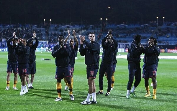 The Arsenal team salute the fans before the match
