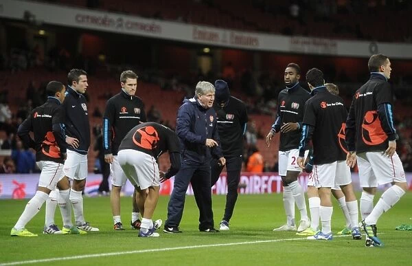 The Arsenal team warm up before the Barclays Premier League match between Arsenal