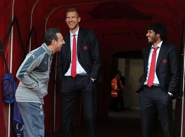Arsenal Triple Threat: Cazorla, Mertesacker, and Elneny's Light-Hearted Moment in the Tunnel Before Arsenal vs. Manchester United (2016-17)