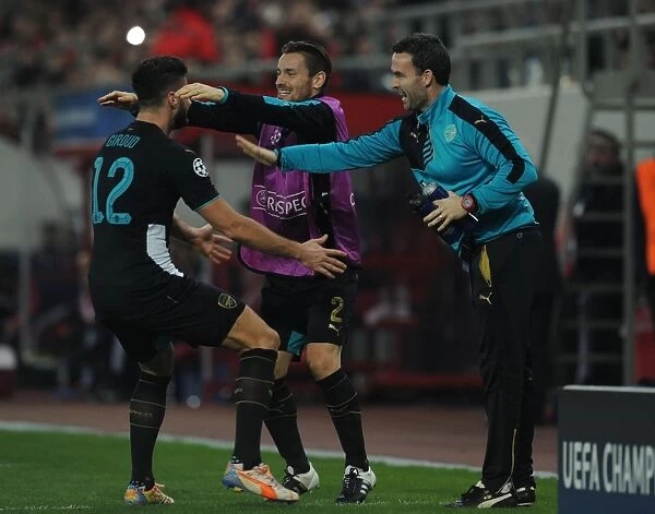 Arsenal Triumph: Giroud, Debuchy, and Forsythe Celebrate Goals Against Olympiacos in the UEFA Champions League