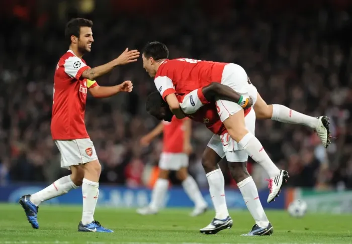 Framed Print : Arsenal Triumph: Nasri, Fabregas, and Eboue Celebrate Double Team Goal vs. Shakhtar Donetsk (5-1), UEFA Champions League, Emirates Stadium