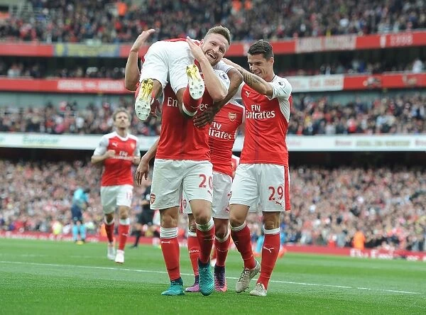 Arsenal Triumph: Walcott, Mustafi, and Xhaka Celebrate Goals Against Swansea City (2016-17)