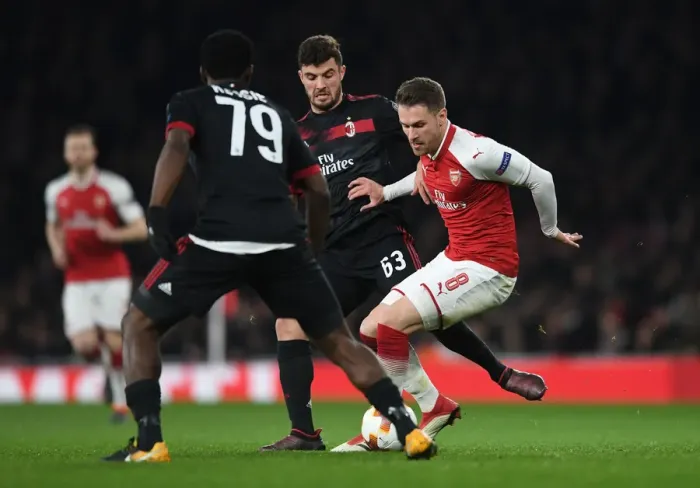 Framed Print : Arsenal vs AC Milan: Ramsey Stands Firm Against Cutrone and Kessie in Europa League Showdown