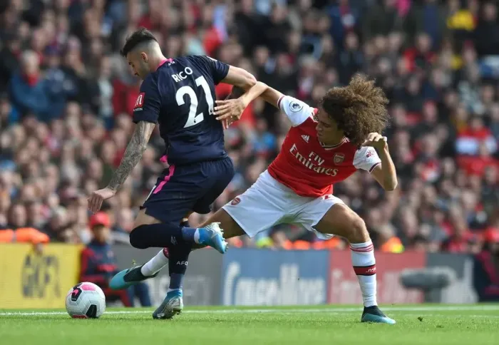Framed Print : Arsenal vs. AFC Bournemouth: Matteo Guendouzi Tackles Diego Rico in Premier League Clash Framed Print : Arsenal vs. AFC Bournemouth: Matteo Guendouzi Tackles Diego Rico in Premier League Clash
