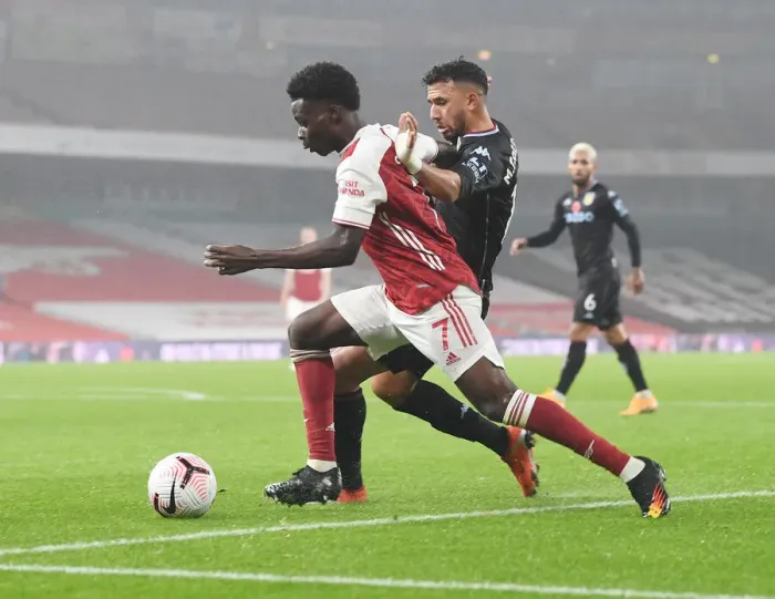 Framed Print : Arsenal vs Aston Villa: Saka Takes on Trezeguet in Empty Emirates Stadium, Premier League 2020-21 Framed Print : Arsenal vs Aston Villa: Saka Takes on Trezeguet in Empty Emirates Stadium, Premier League 2020-21