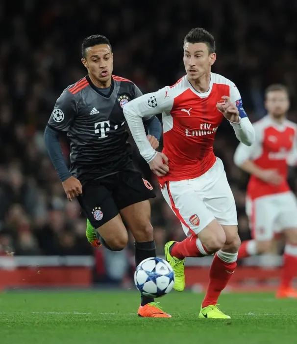 Framed Print : Arsenal vs. Bayern Munich: Laurent Koscielny vs. Thiago Alcantara - UEFA Champions League Showdown