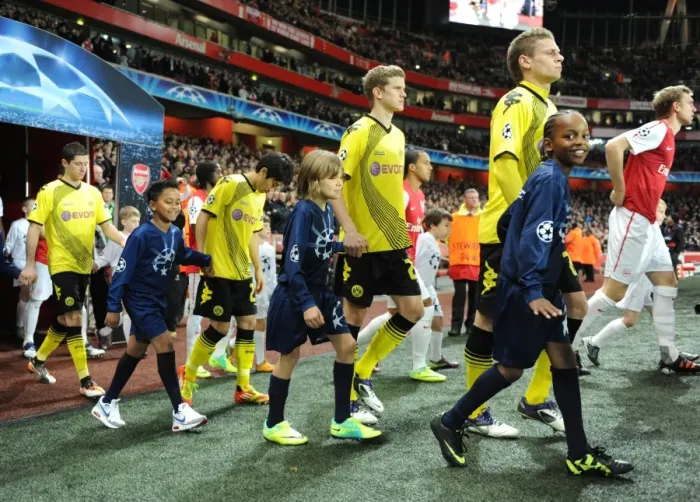 Framed Print : Arsenal vs Borussia Dortmund: Champion League Showdown at Emirates Stadium (2011-12) - Player Escorts
