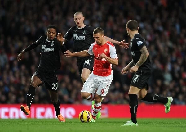 Arsenal vs Burnley: Intense Battle – Lukas Podolski vs Chalobah, Jones, and Trippier