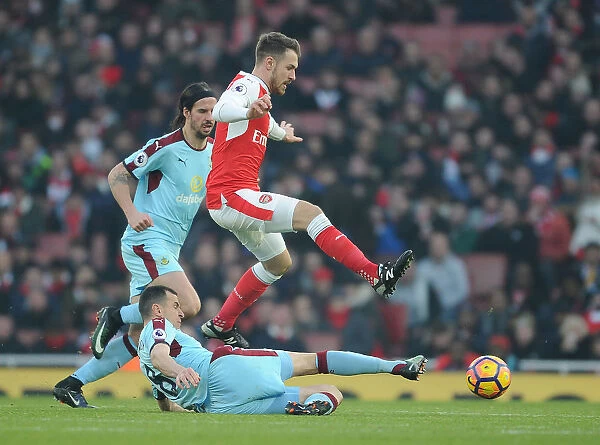 Arsenal vs. Burnley: Intense Clash between Aaron Ramsey and Dean Marney in the Premier League
