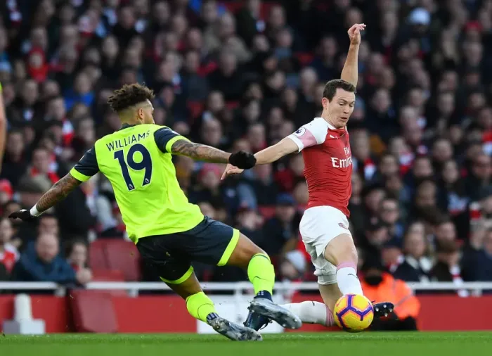 Framed Print : Arsenal vs. Huddersfield: Lichtsteiner Tackles Williams in Premier League Clash Framed Print : Arsenal vs. Huddersfield: Lichtsteiner Tackles Williams in Premier League Clash