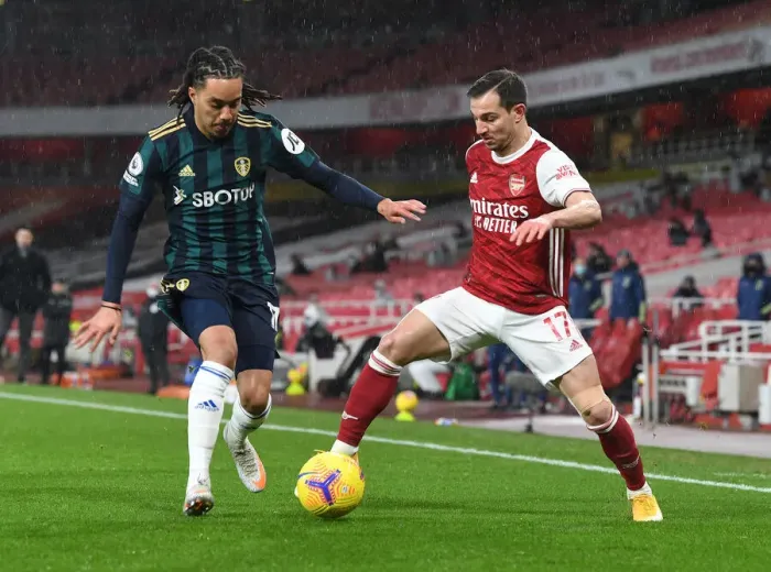 Framed Print : Arsenal vs Leeds United: Cedric Clashes with Helder Costa in Premier League Showdown