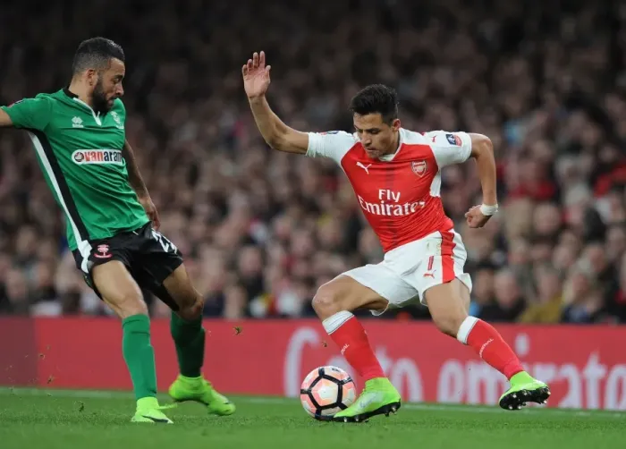Framed Print : Arsenal vs. Lincoln City: Tense Clash Between Alexis Sanchez and Nathan Arnold in FA Cup Quarter-Final