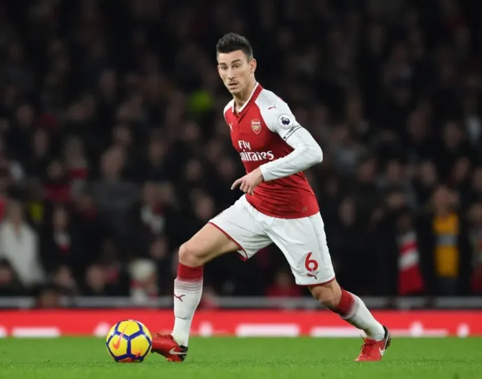 Framed Print : Arsenal vs. Liverpool: Koscielny's Intense Showdown in the Premier League