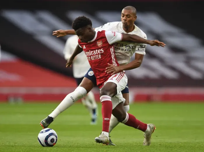Framed Print : Arsenal vs Manchester City: Bukayo Saka Clashes with Fernandinho in Empty Emirates Stadium