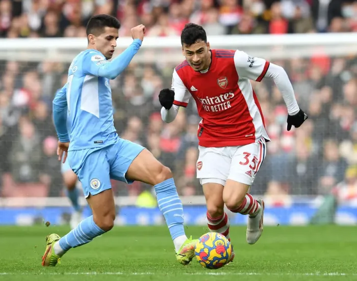 Framed Print : Arsenal vs Manchester City: Gabriel Martinelli Clashes with Joao Cancelo in Premier League Showdown