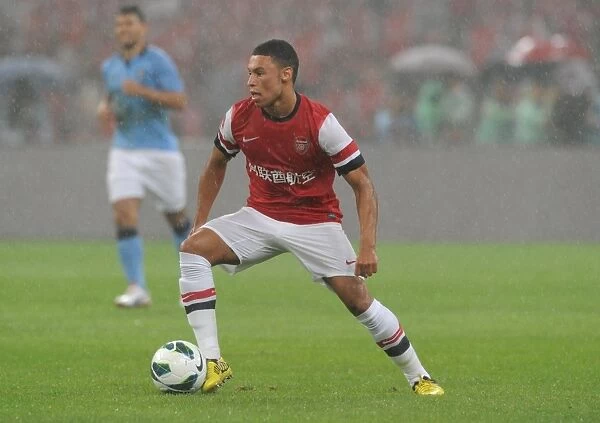 Arsenal vs Manchester City: Oxlade-Chamberlain in Action during 2012 Pre-Season Clash in Beijing