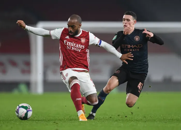 Framed Print : Arsenal vs Manchester City Rivalry: Lacazette vs Foden - Emirates Showdown in Empty Carabao Cup Quarterfinals