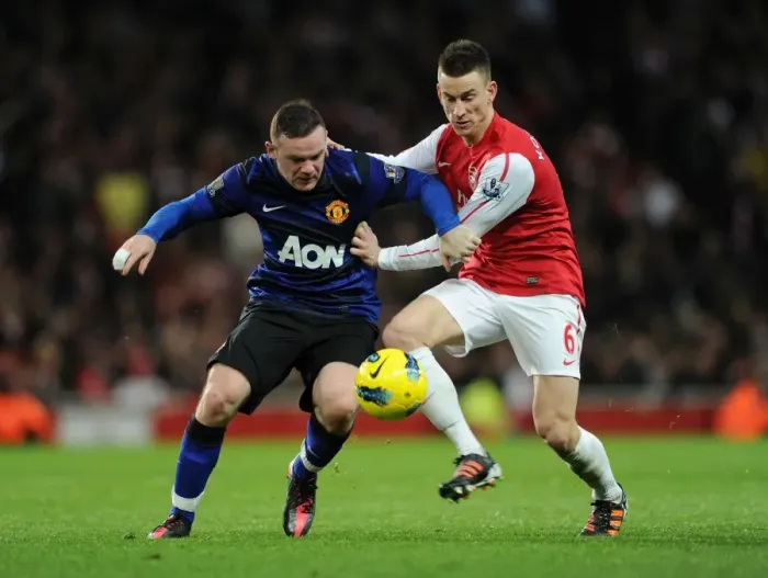 Framed Print : Arsenal vs Manchester United: Koscielny Tackles Rooney in Intense Premier League Clash