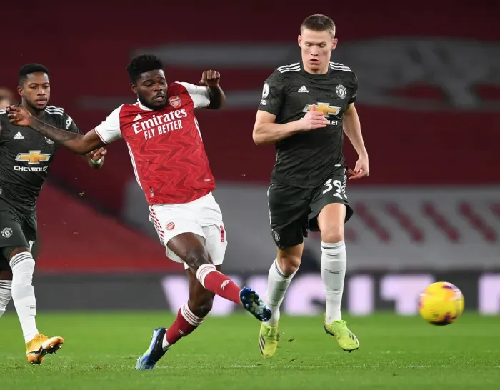 Framed Print : Arsenal vs Manchester United: Thomas Partey Faces Off Against Scott McTominay in Empty Emirates Stadium, Premier League 2021 Framed Print : Arsenal vs Manchester United: Thomas Partey Faces Off Against Scott McTominay in Empty Emirates Stadium, Premier League 2021