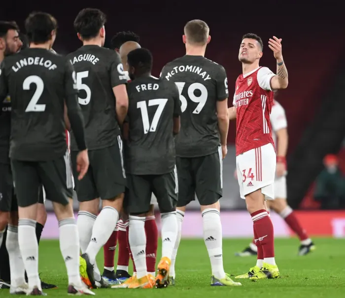 Framed Print : Arsenal vs Manchester United: Xhaka's Heated Clash Amid Empty Emirates Stadium (Premier League 2020-21) Framed Print : Arsenal vs Manchester United: Xhaka's Heated Clash Amid Empty Emirates Stadium (Premier League 2020-21)