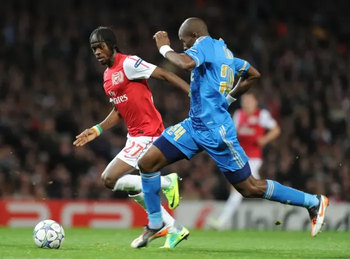Framed Print : Arsenal vs Marseille: Intense Battle Between Gervinho and Rod Fanni in the 2011-12 UEFA Champions League