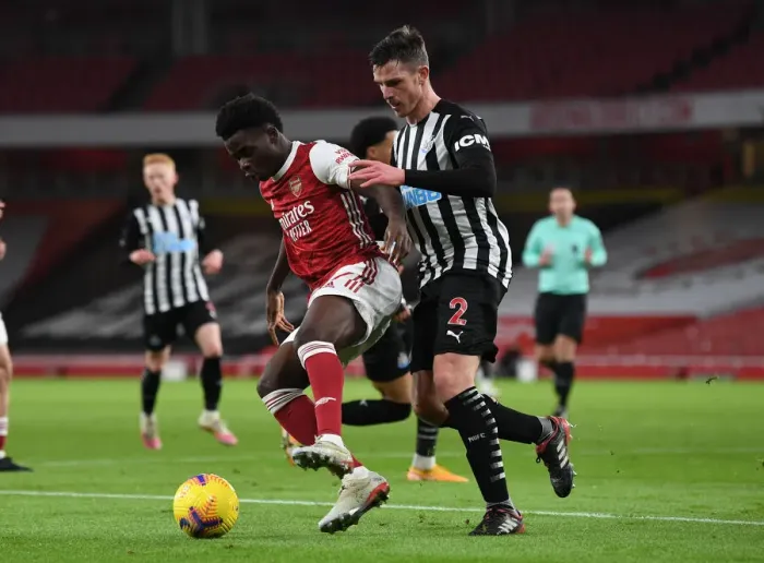 Framed Print : Arsenal vs Newcastle United: Bukayo Saka Faces Off Against Ciaran Clark Amid Empty Emirates Stadium (Premier League 2020-21)