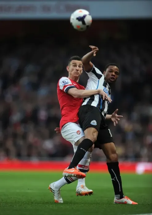 Framed Print : Arsenal vs Newcastle United: Koscielny vs Remy in Intense Battle