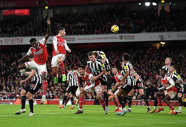 Arsenal vs Newcastle United: Thomas Partey and Gabriel Martinelli Leap for the Ball in Premier League Clash (2022-23)