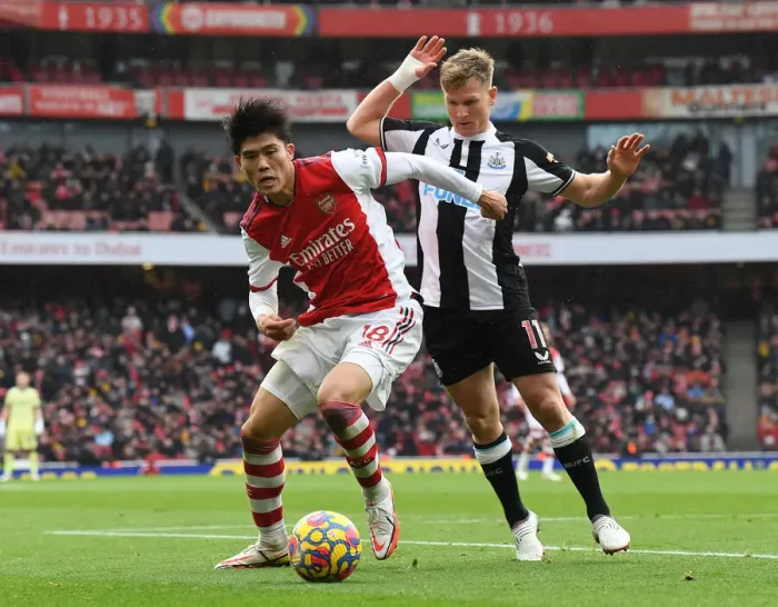 Framed Print : Arsenal vs Newcastle United: Tomiyasu Tangles with Ritchie in Premier League Clash