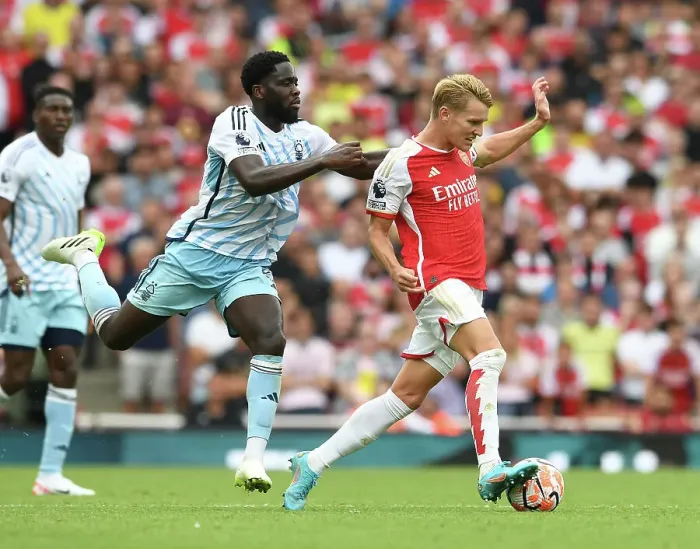 Framed Print : Arsenal vs. Nottingham Forest: Martin Odegaard Tackled by Orel Mangala in 2023-24 Premier League Clash Framed Print : Arsenal vs. Nottingham Forest: Martin Odegaard Tackled by Orel Mangala in 2023-24 Premier League Clash