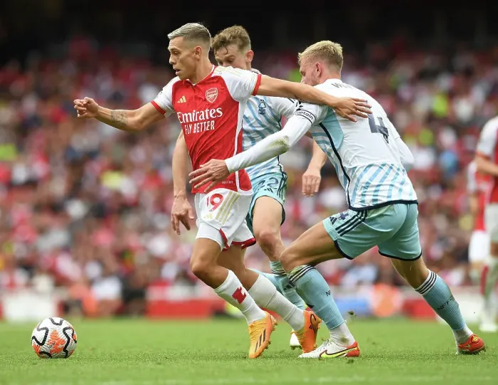 Framed Print : Arsenal vs. Nottingham Forest: Trossard Tangles with Worrall in 2023-24 Premier League Clash