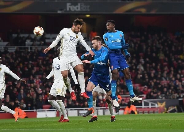 Arsenal vs Östersunds FK: Intense Aerial Battle Between Danny Welbeck and Sotirios Papagiannopoulos, Calum Chambers