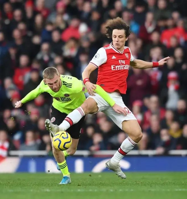 Framed Print : Arsenal vs Sheffield United: A Battle Between David Luiz and Oli McBurnie at the Emirates Stadium