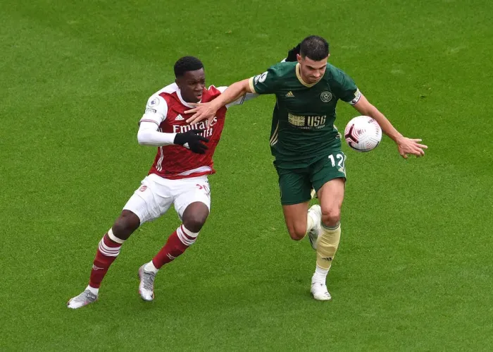 Framed Print : Arsenal vs Sheffield United: Eddie Nketiah Clashes with John Egan in Premier League Showdown