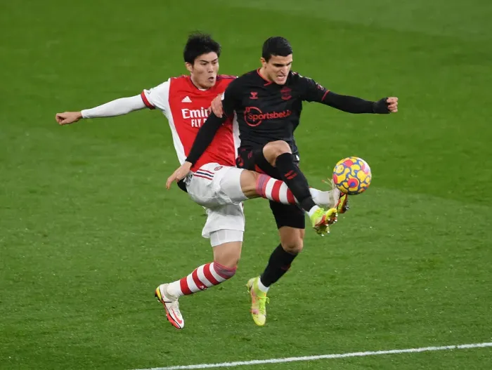 Framed Print : Arsenal vs Southampton: Tomiyasu vs Elyounoussi Clash in Premier League Showdown